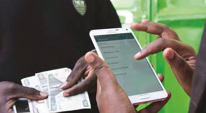 A picture showing money being deposited to an M-Pesa account